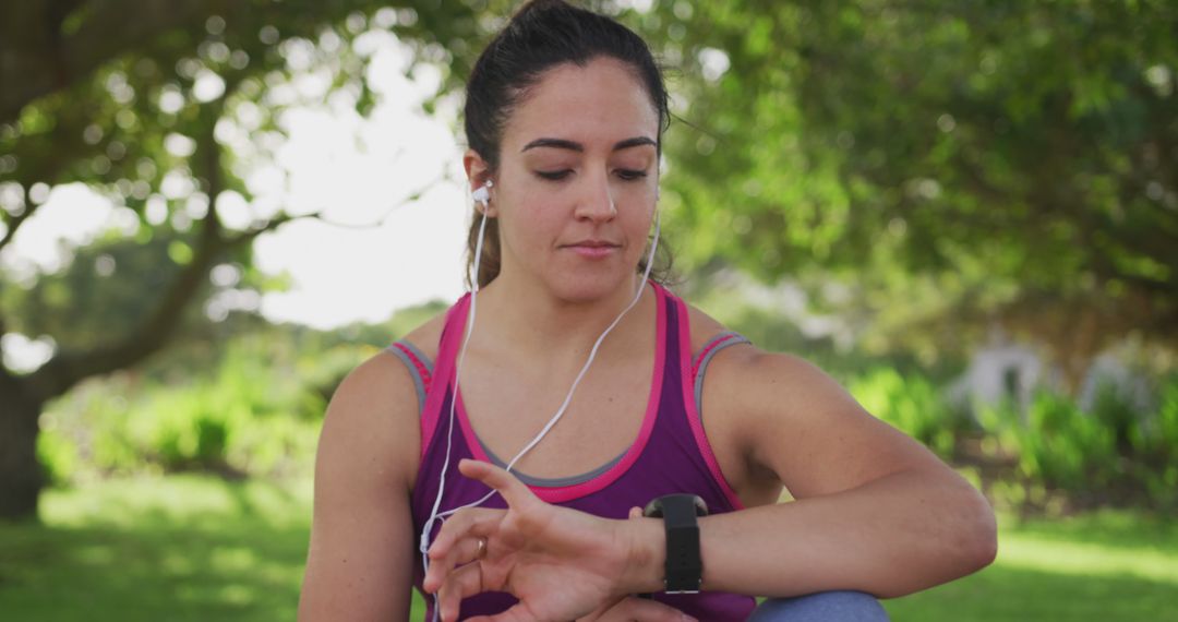 Female athlete checking smartwatch during outdoor workout session - Free Images, Stock Photos and Pictures on Pikwizard.com