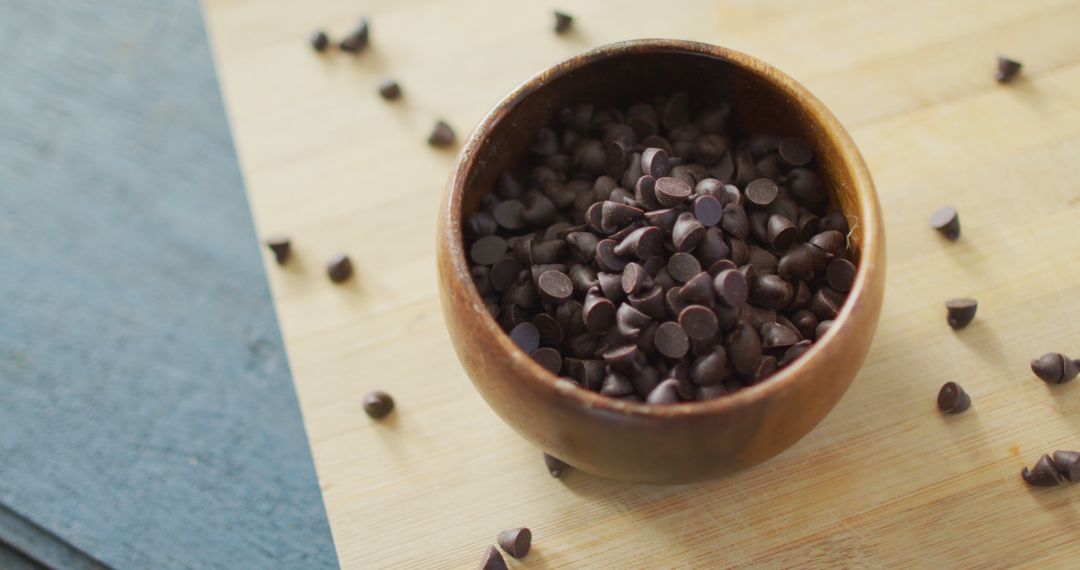 Organic Chocolate Chips in Wooden Bowl on Rustic Surface - Free Images, Stock Photos and Pictures on Pikwizard.com