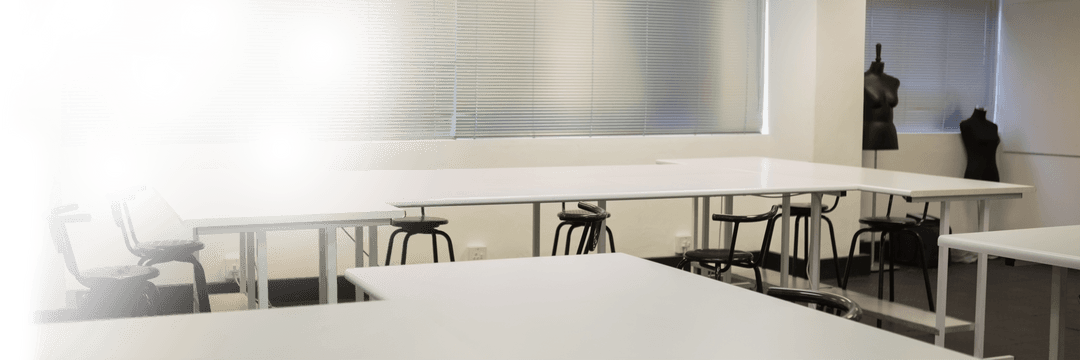 Transparent Unoccupied Workspace with Chic White Desks and Stylish Stools