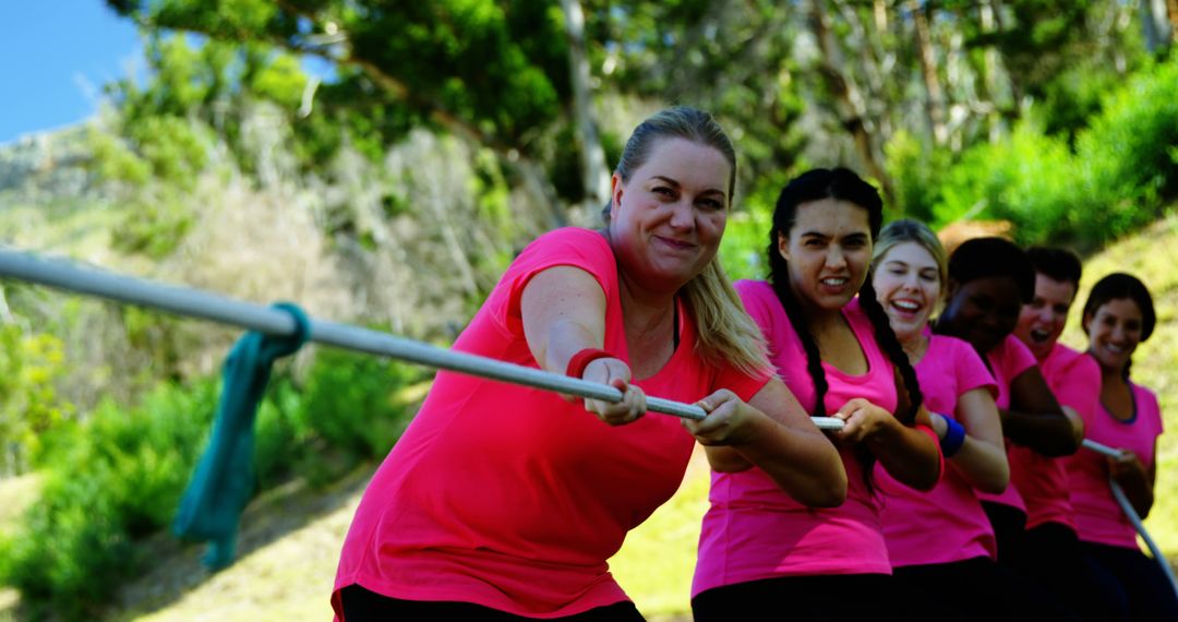 Team of women participating in outdoor tug of war competition - Free Images, Stock Photos and Pictures on Pikwizard.com