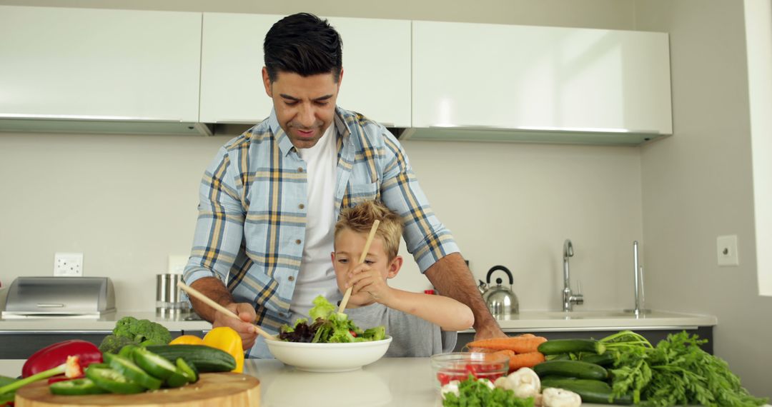 Father and Son Preparing Healthy Salad Together in Modern Kitchen - Free Images, Stock Photos and Pictures on Pikwizard.com