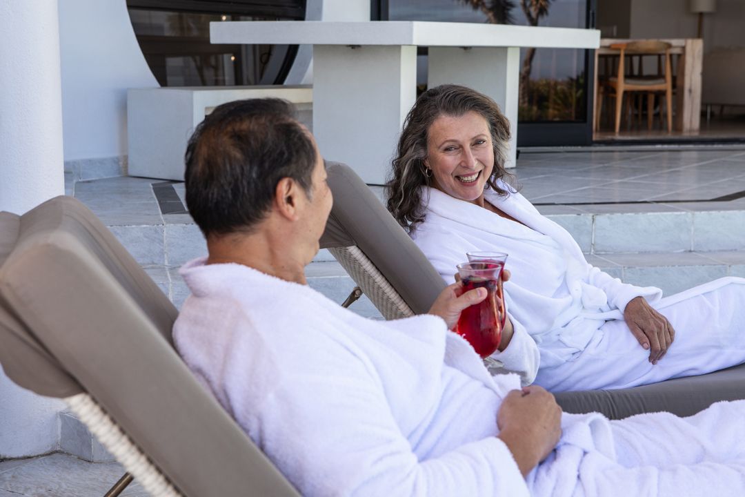 Diverse Senior Couple Relaxing in Spa Environment Enjoying Refreshing Drink