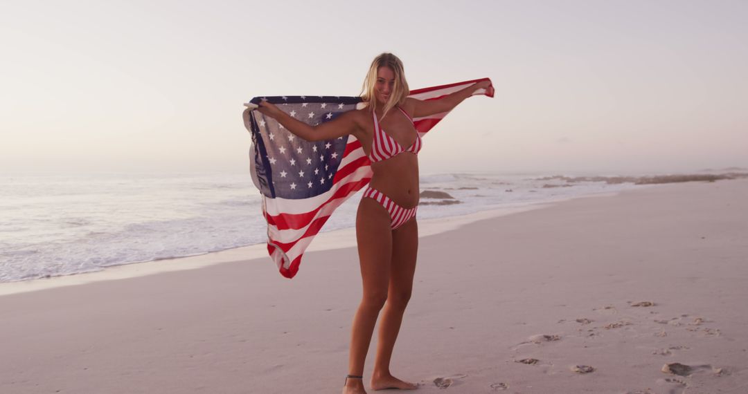 Woman on Beach Holding American Flag in Red Bikini - Free Images, Stock Photos and Pictures on Pikwizard.com