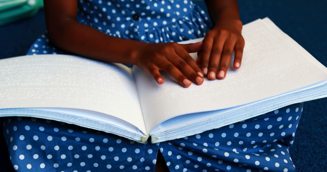 Blind Child Reading Braille Book in Blue Polka Dot Dress - Free Images, Stock Photos and Pictures on Pikwizard.com