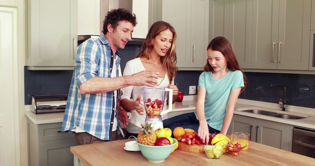 Joyful Family Preparing Fresh Smoothie Together in Modern Kitchen - Free Images, Stock Photos and Pictures on Pikwizard.com