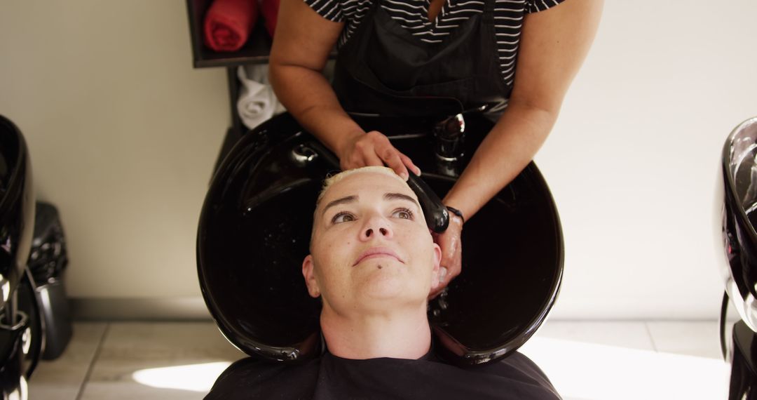 Person Relaxing During Professional Hair Washing in Salon - Free Images, Stock Photos and Pictures on Pikwizard.com