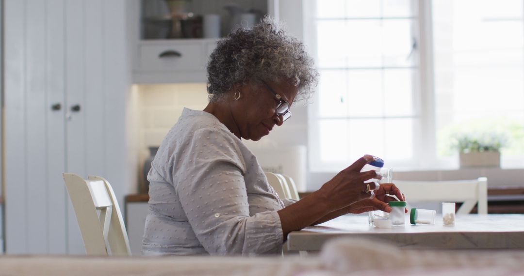 Senior Woman Taking Medication at Home During Daytime - Free Images, Stock Photos and Pictures on Pikwizard.com