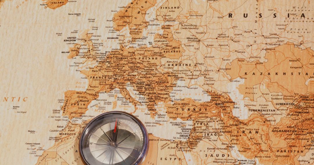 Compass Sitting on Vintage World Map of Europe and Asia