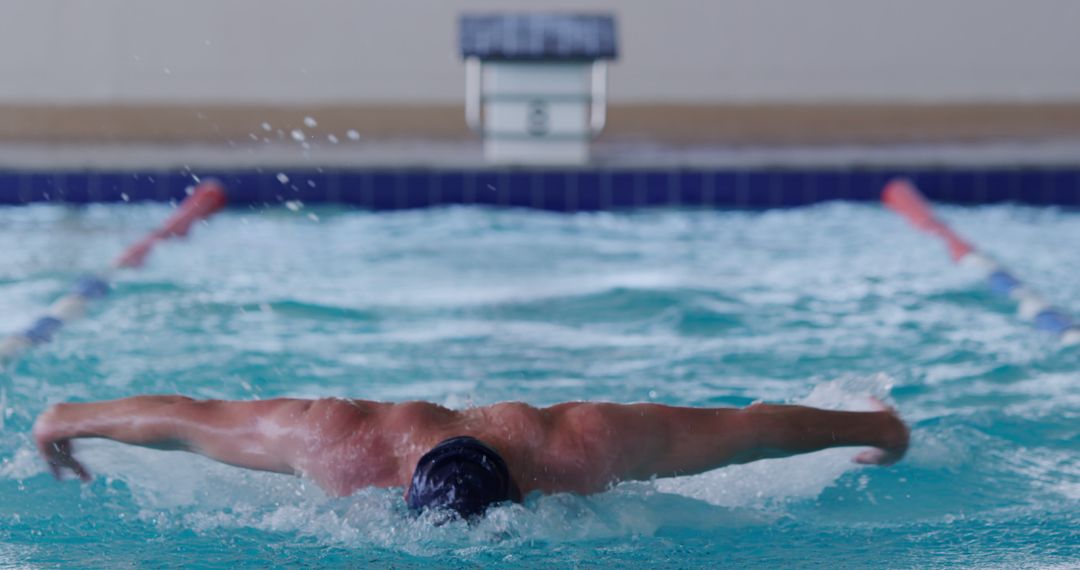 Athlete Practicing Butterfly Stroke in Swimming Pool - Free Images, Stock Photos and Pictures on Pikwizard.com