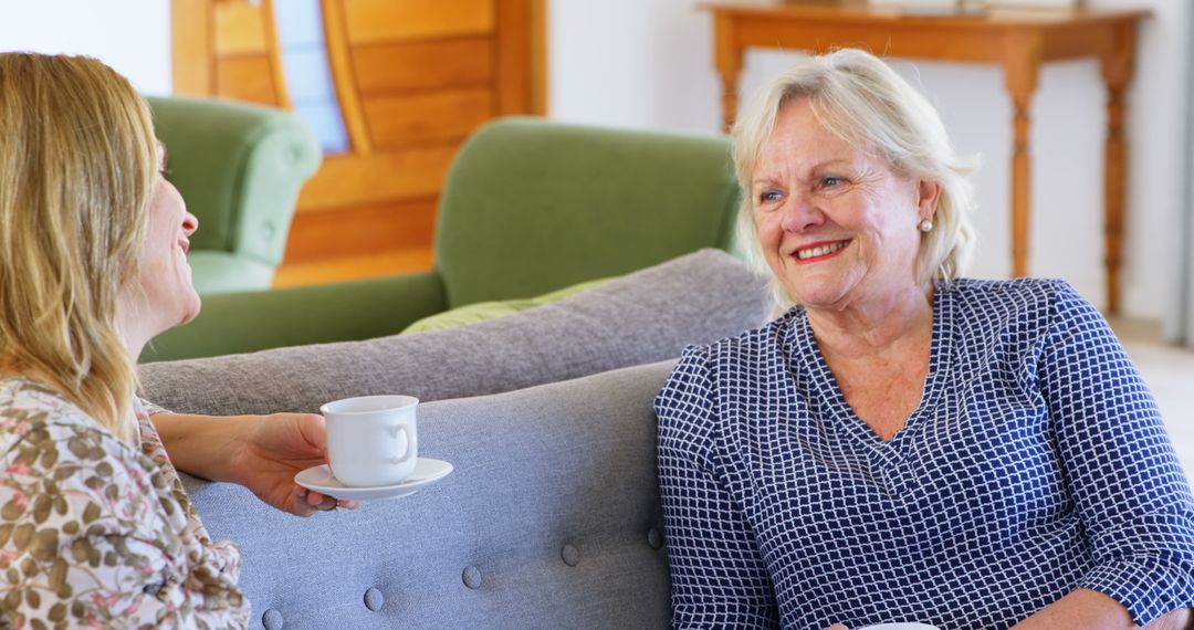 Senior Woman Enjoying Conversation with Middle-Aged Woman at Home - Free Images, Stock Photos and Pictures on Pikwizard.com