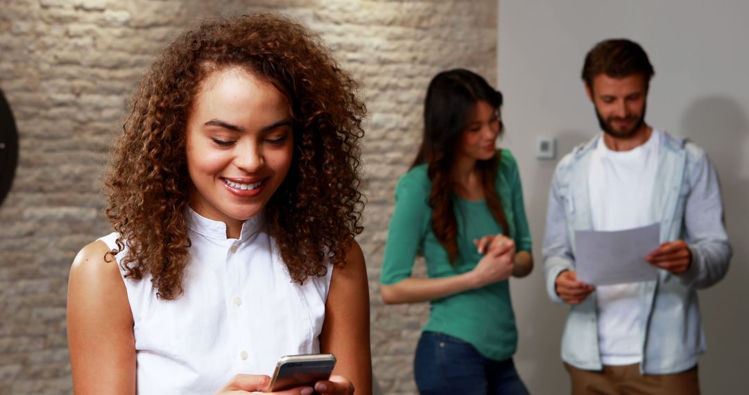Confident Female Executive Using Smartphone in Modern Office