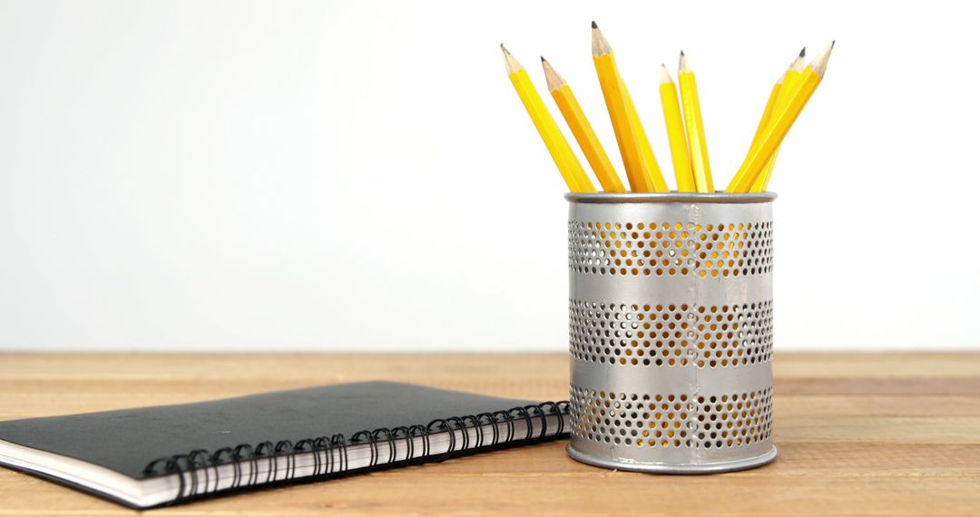 Yellow Pencils in Metal Holder with Spiral Notebook on Wooden Desk - Free Images, Stock Photos and Pictures on Pikwizard.com