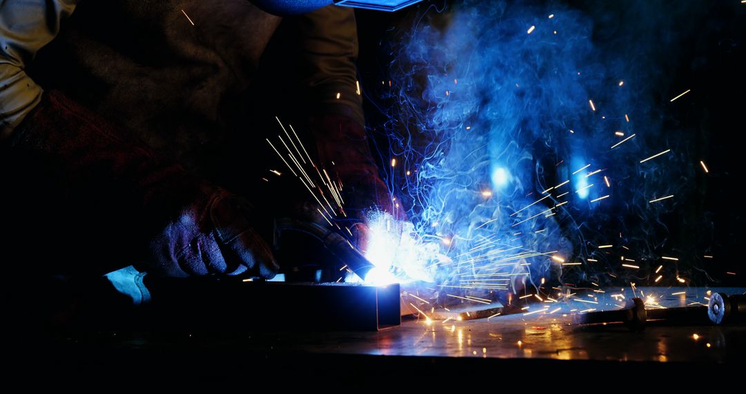 Worker Welding Metal at Night with Sparks Flying - Free Images, Stock Photos and Pictures on Pikwizard.com