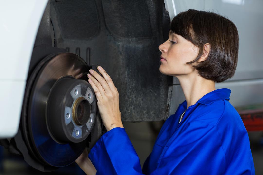 Female Mechanic Inspecting Car Disc Brake in Auto Repair Shop - Free Images, Stock Photos and Pictures on Pikwizard.com