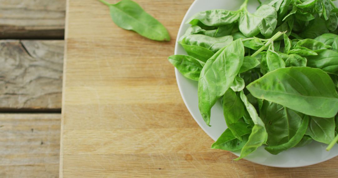 Fresh Organic Spinach Leaves in White Bowl on Wooden Table - Free Images, Stock Photos and Pictures on Pikwizard.com