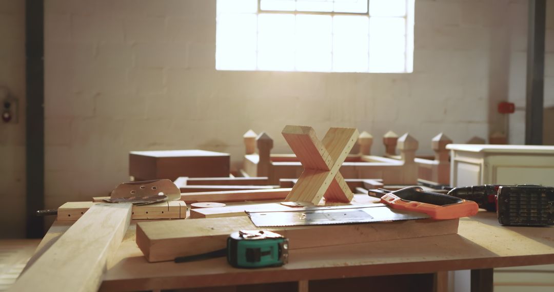 X-Shaped Woodwork on Workshop Bench with Tools and Sunlight
