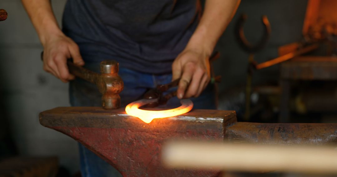 Blacksmith Shaping Glowing Hot Metal with Hammer on Anvil - Free Images, Stock Photos and Pictures on Pikwizard.com