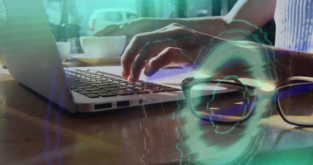 Hands on Laptop with Digital Overlay of Cybersecurity Elements