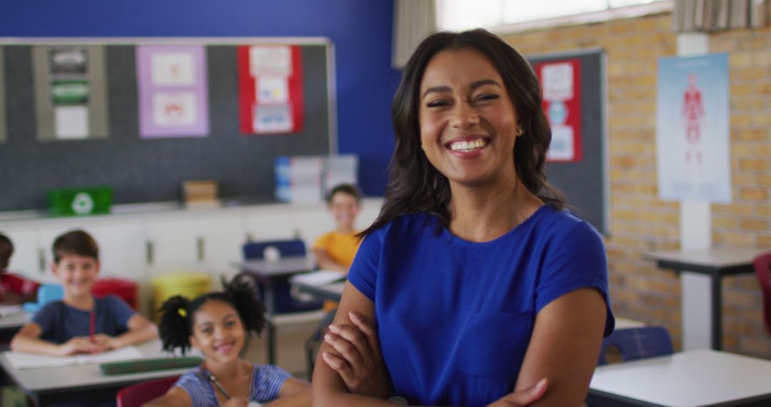 Portrait of happy biracial female teacher standing in classroom with children in background - Free Images, Stock Photos and Pictures on Pikwizard.com