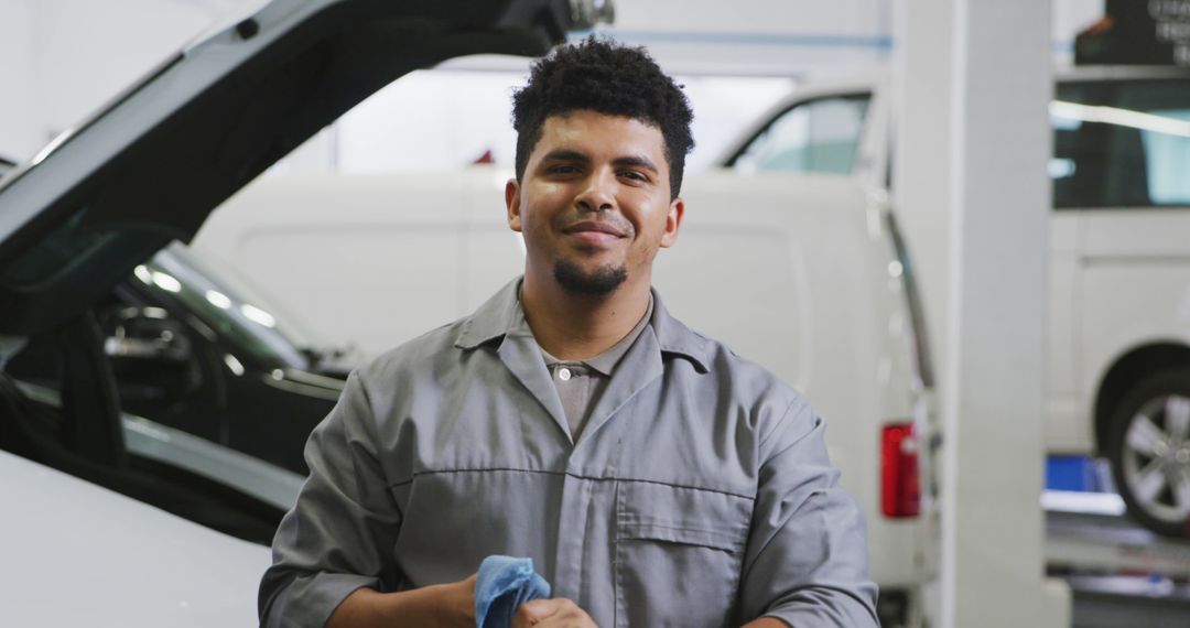 Confident Auto Mechanic Smiling in Garage Workshop - Free Images, Stock Photos and Pictures on Pikwizard.com