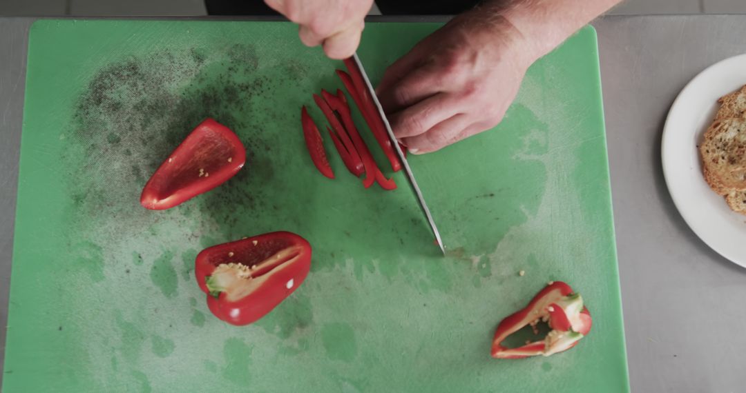 Chef Hands Slicing Red Bell Pepper on Green Cutting Board - Free Images, Stock Photos and Pictures on Pikwizard.com