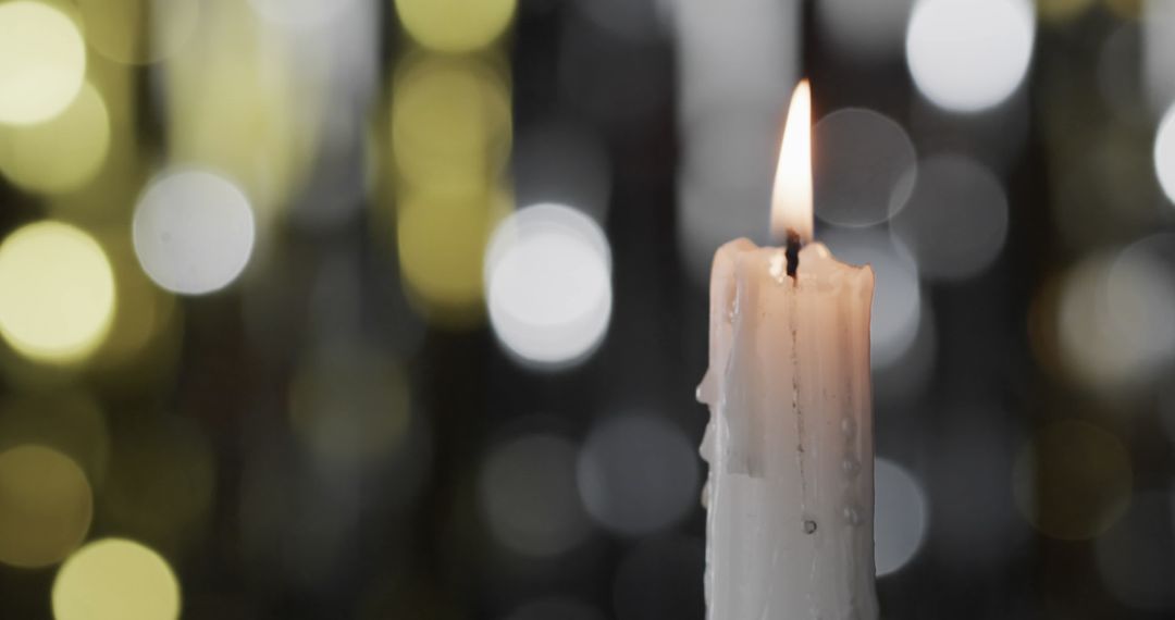 Christmas Candle with Festive Bokeh Lights