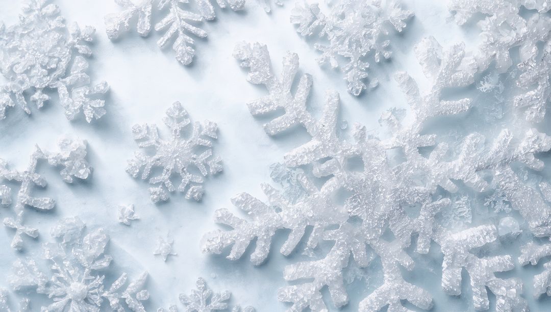 Glittering snowflakes forming crystalline winter background with pale blue frosted texture