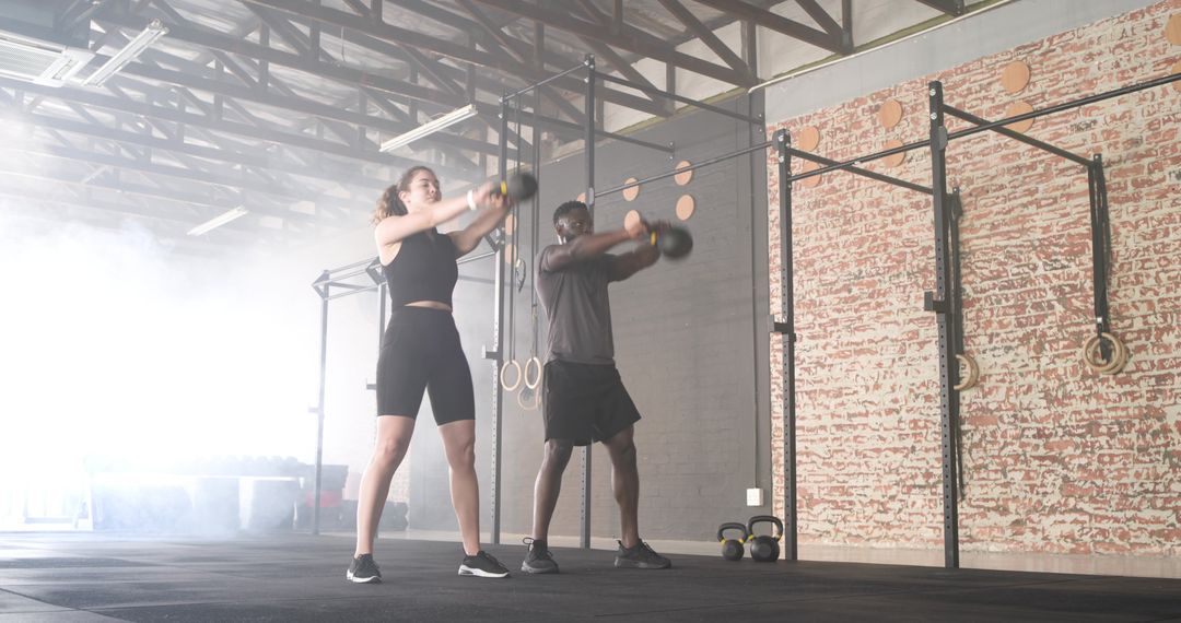 Diverse Individuals Performing Kettlebell Workout in Modern Gym