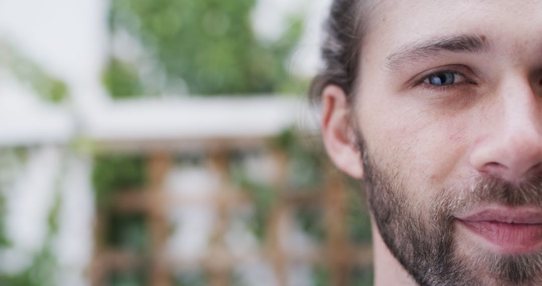 Close-Up of Young Bearded Man with Long Hair Outdoors - Free Images, Stock Photos and Pictures on Pikwizard.com