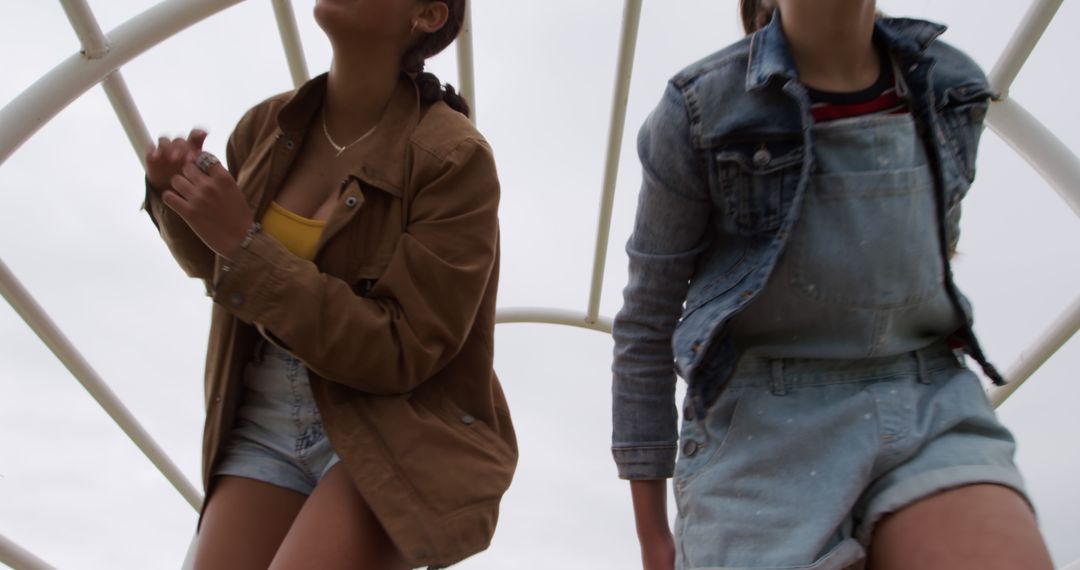 Two Young Women Outdoors Wearing Denim and Casual Jackets - Free Images, Stock Photos and Pictures on Pikwizard.com