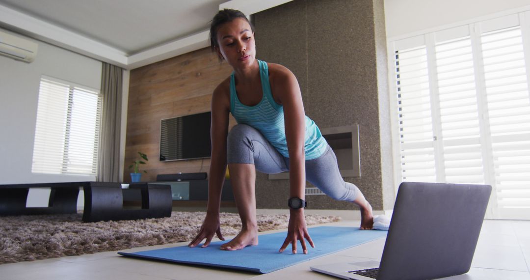 Woman Practicing Yoga at Home with Laptop for Virtual Fitness - Free Images, Stock Photos and Pictures on Pikwizard.com