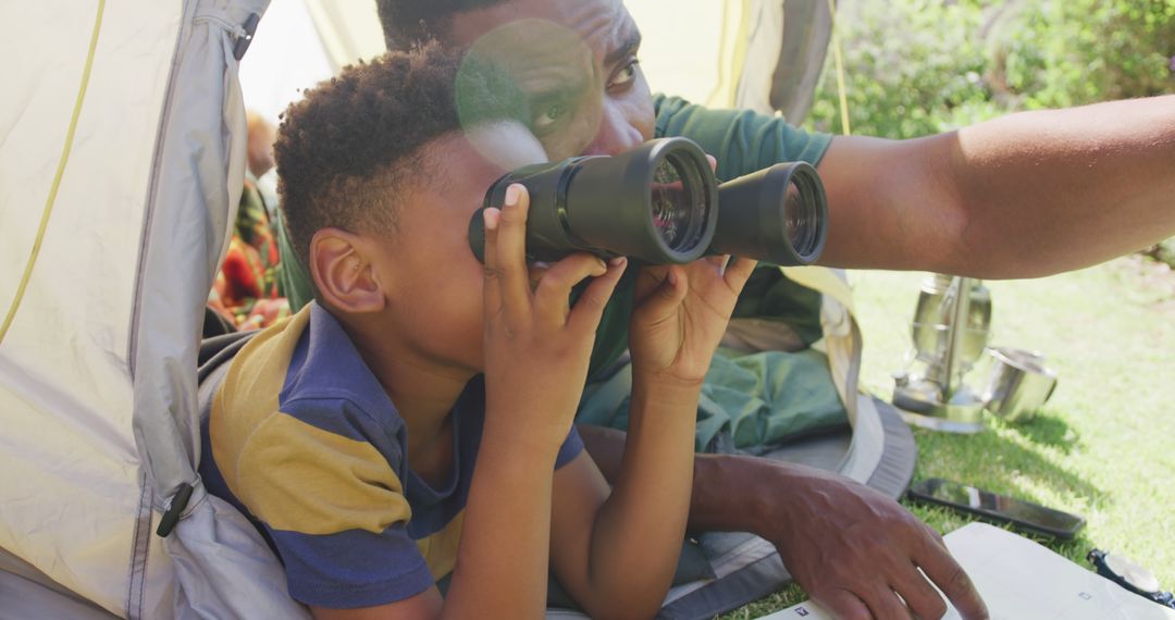 Father and Son Using Binoculars on Camping Trip - Free Images, Stock Photos and Pictures on Pikwizard.com