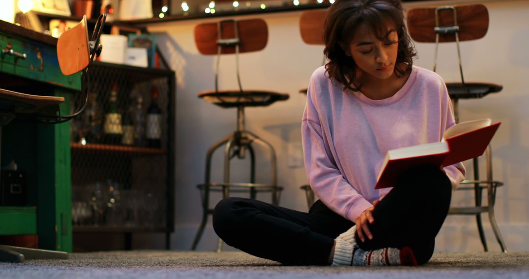 Young Woman Reading Book in Cozy Living Room - Free Images, Stock Photos and Pictures on Pikwizard.com