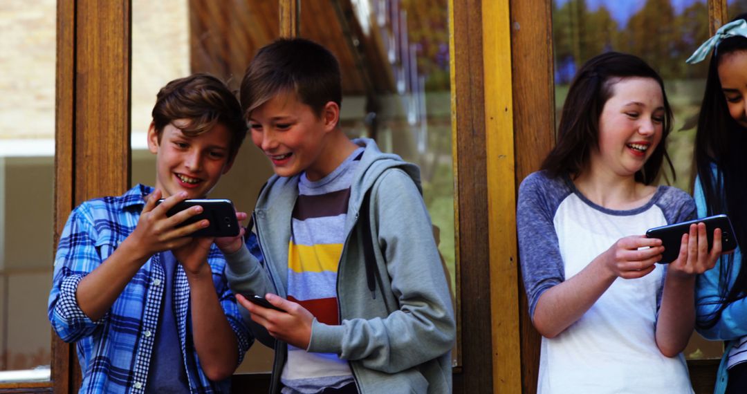 Group of Happy Teens Using Smartphones Outside - Free Images, Stock Photos and Pictures on Pikwizard.com