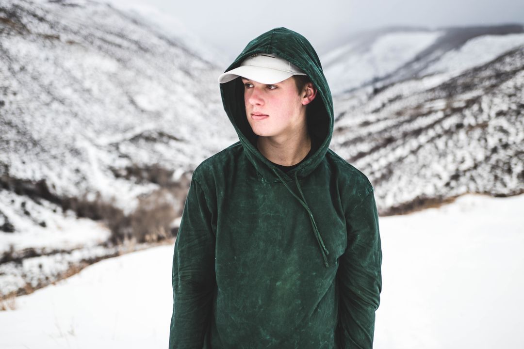Young Man Wearing Hooded Jacket in Snowy Mountains - Free Images, Stock Photos and Pictures on Pikwizard.com