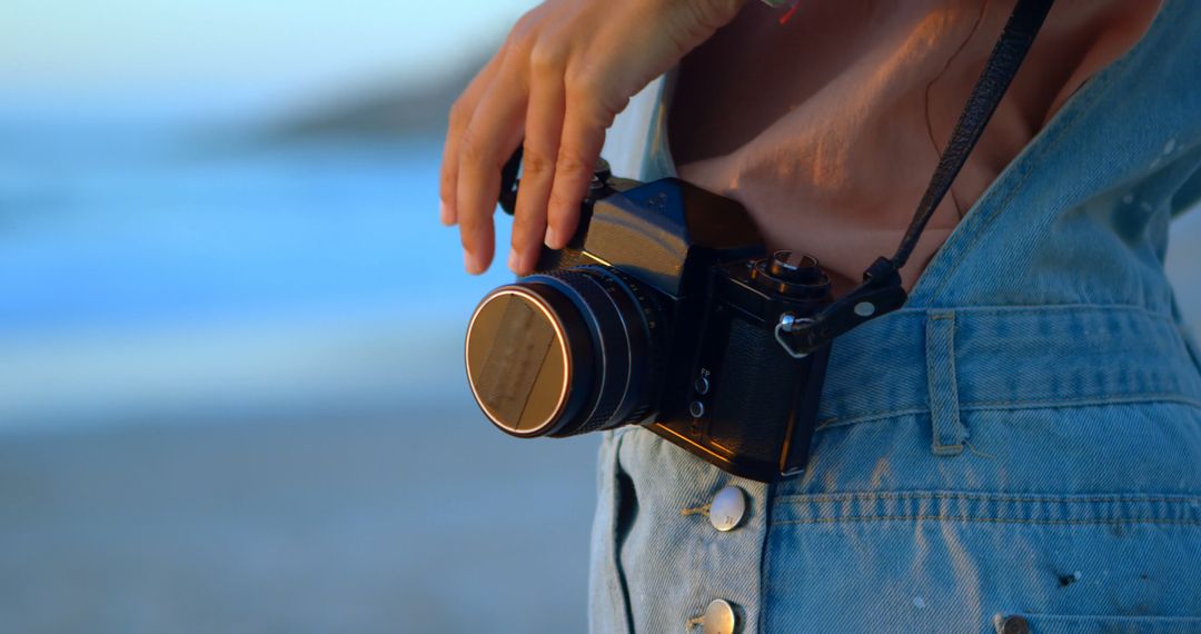 Vintage Camera Held by on Beach at Sunset