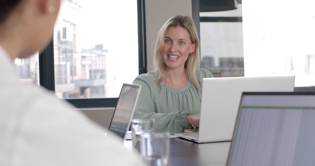 Smiling Businesswoman Interacting in Modern Office Meeting - Free Images, Stock Photos and Pictures on Pikwizard.com