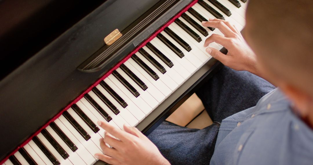 Hands Playing Piano from Above Creating Music at Home