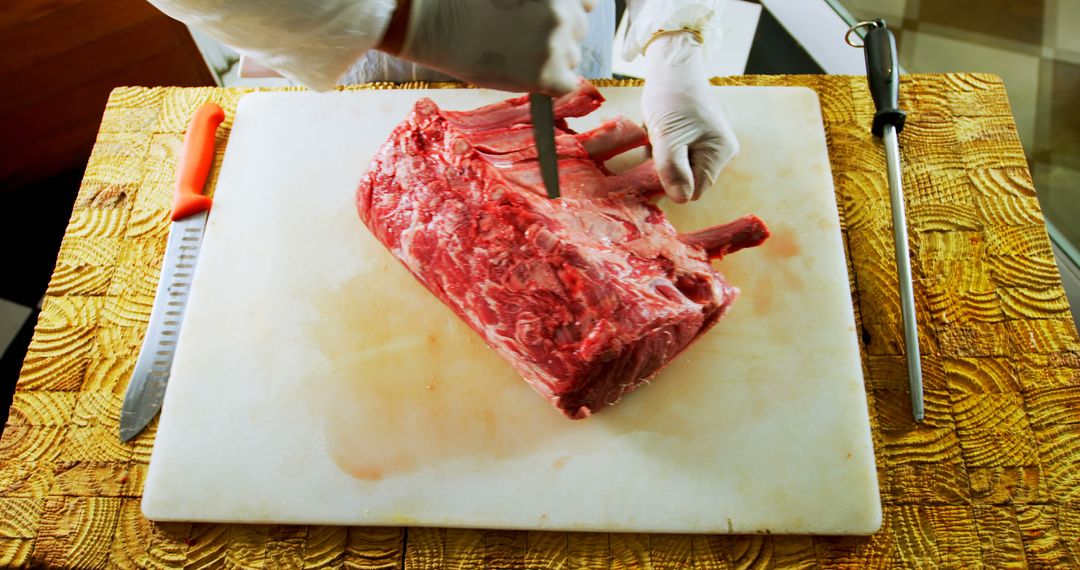 Butcher Cutting Raw Beef Rib Eye on Wooden Board - Free Images, Stock Photos and Pictures on Pikwizard.com