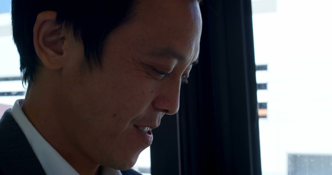 Happy Man Riding City Bus Looking Down