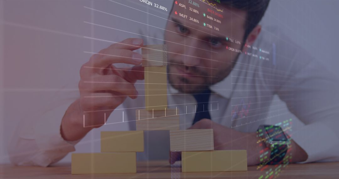 Image of stock market data processing over caucasian businessman playing with building blocks - Free Images, Stock Photos and Pictures on Pikwizard.com