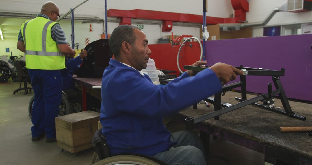 Workers with Disabilities Assembling Equipment in Industrial Workshop - Free Images, Stock Photos and Pictures on Pikwizard.com