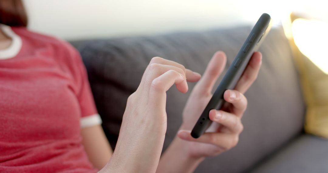 Teenage Girl Engaged with Smartphone at Home in Close-Up