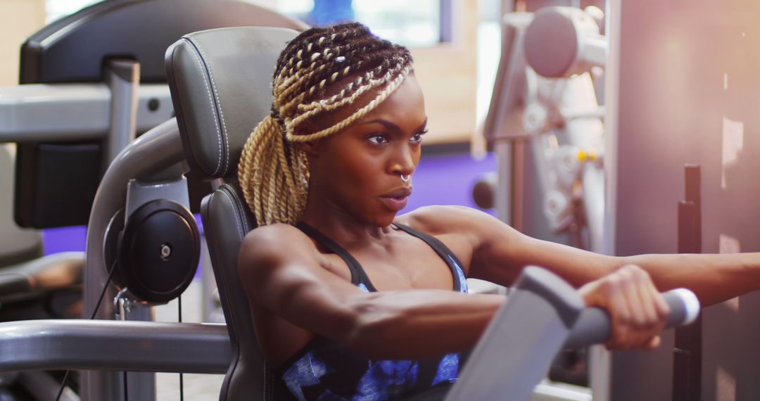 Determined Woman Exercising on Rowing Machine in Gym - Free Images, Stock Photos and Pictures on Pikwizard.com