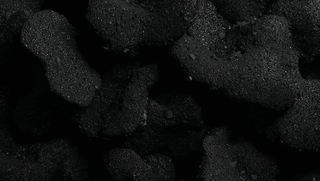 Macro Close-up Coal Texture Showing Granular Porous Lumps with Mineral Flecks in Low Light