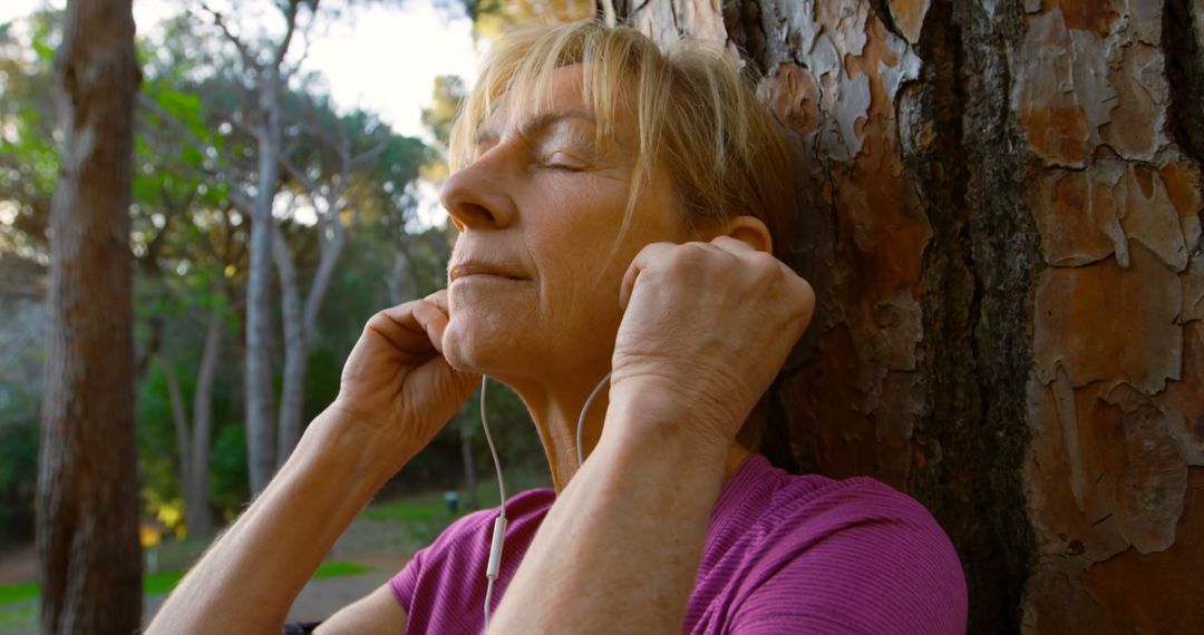 Senior Woman Relaxing with Music in Nature - Free Images, Stock Photos and Pictures on Pikwizard.com