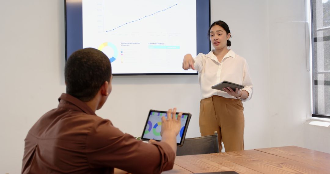 Multiracial Business Team Engaging in Tech-Driven Meeting Presentation