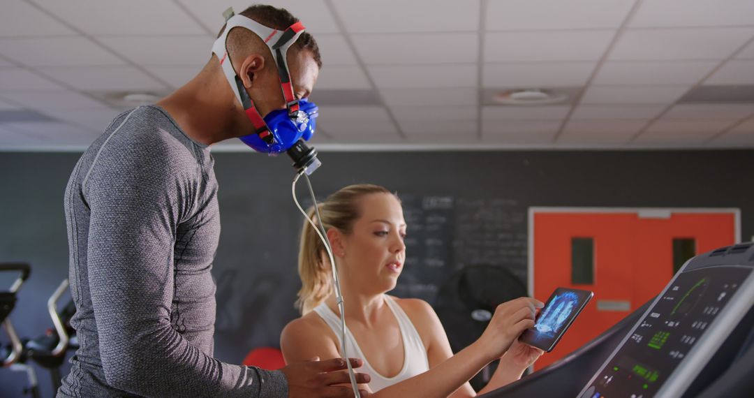 Fitness Trainer Monitoring Man with Respiratory Mask on Treadmill - Free Images, Stock Photos and Pictures on Pikwizard.com