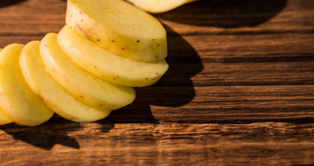 Close-Up of Raw Potato Slices on Rustic Wooden Table