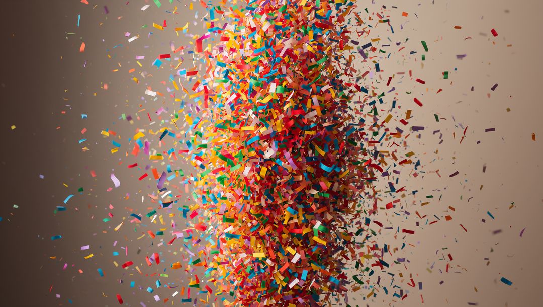 Bursting multicolor confetti column forming dense vertical core with motion and depth